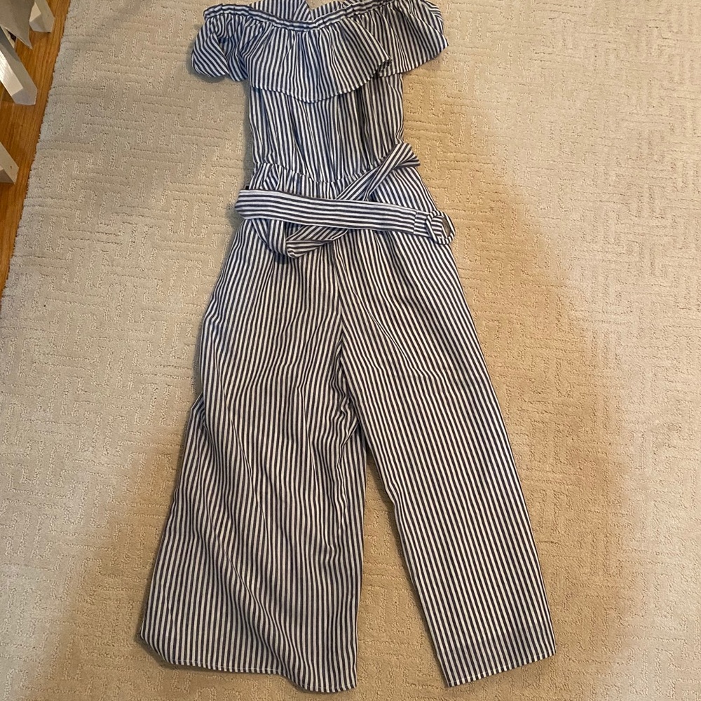 Vestique jumpsuit with belt to cinch waist.